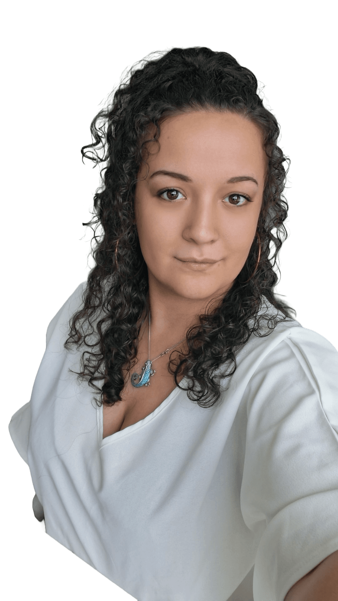 Woman with dark curly hair, wearing a white V-neck top and a blue lizard necklace.